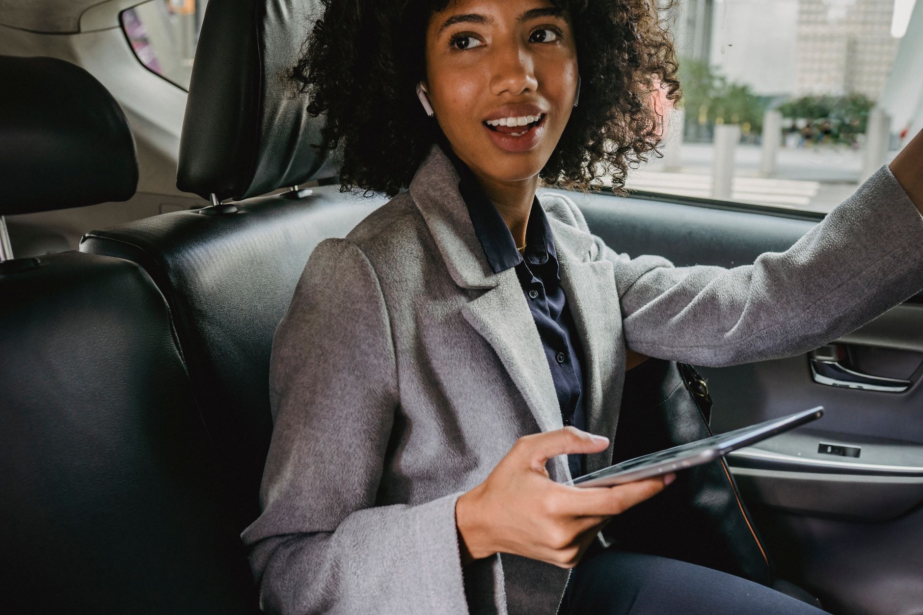 woman in suit in car