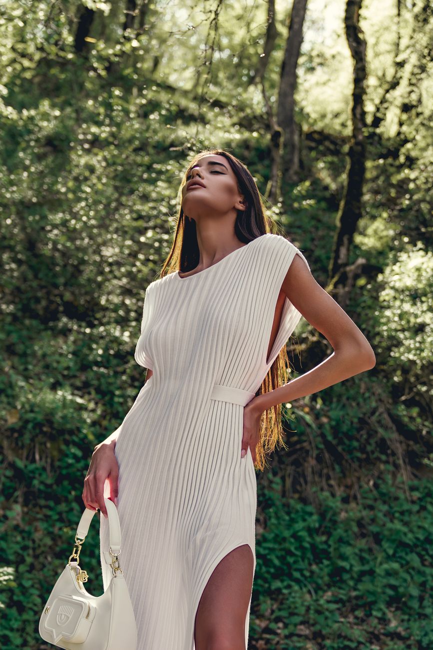 woman posing in white dress