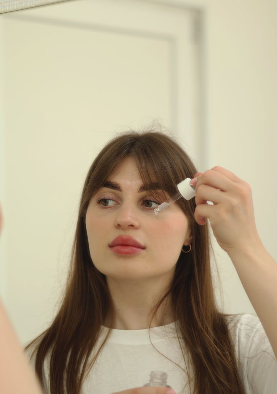 woman putting drops in eye