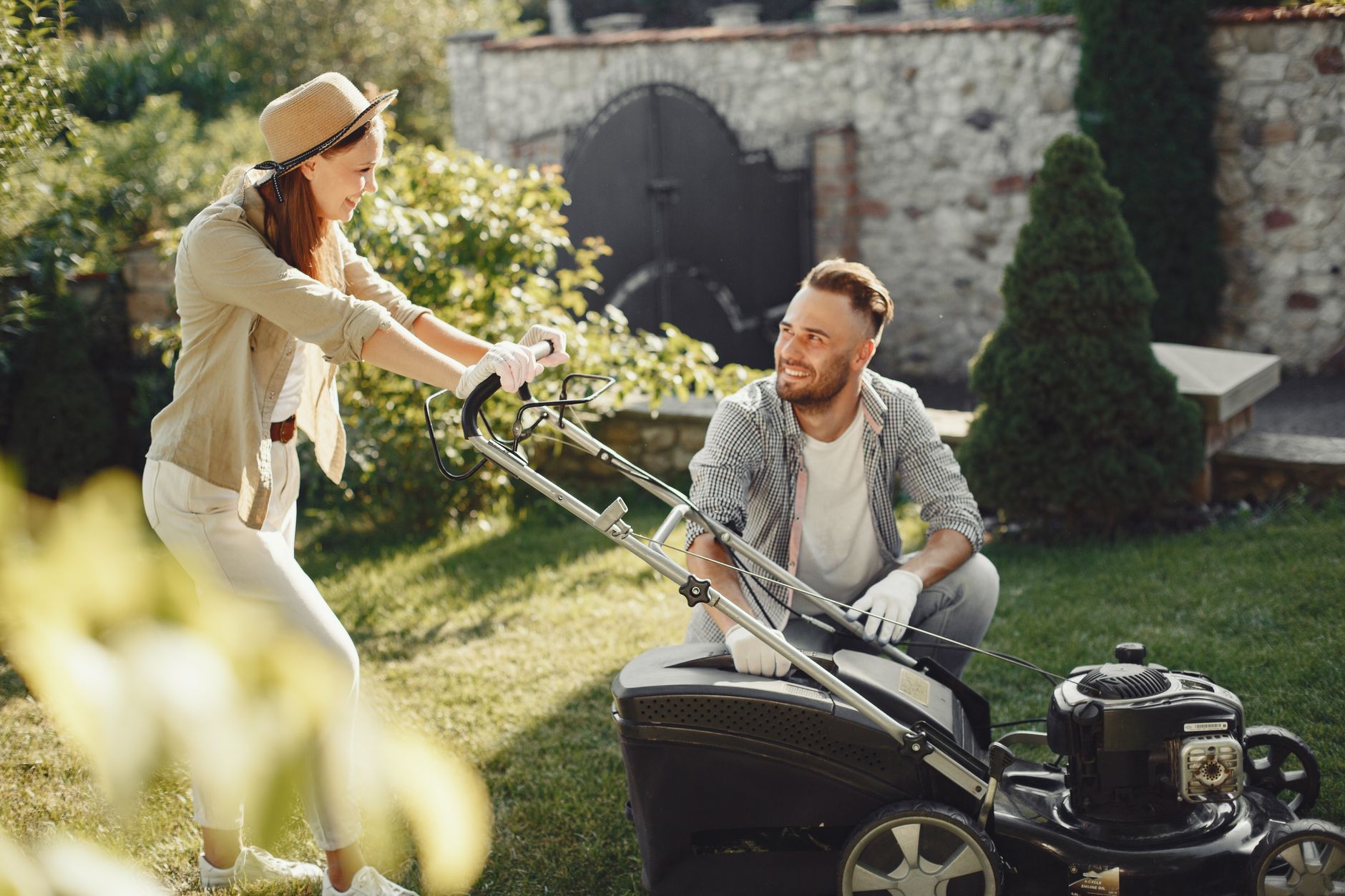 woman in brown long sleeve shirt holding grass cutter