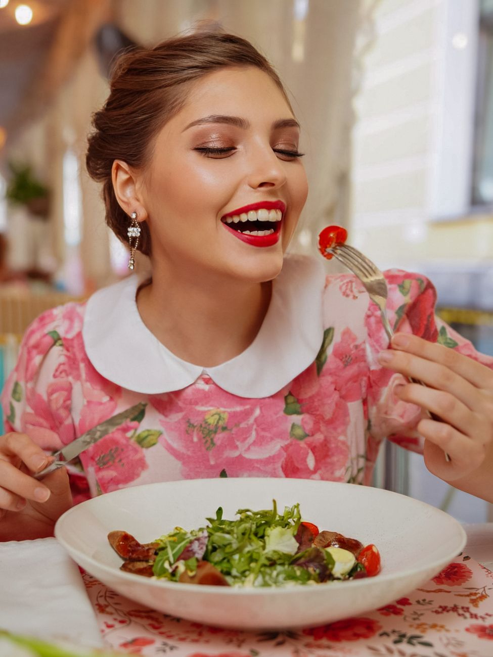 smiling woman eating salad