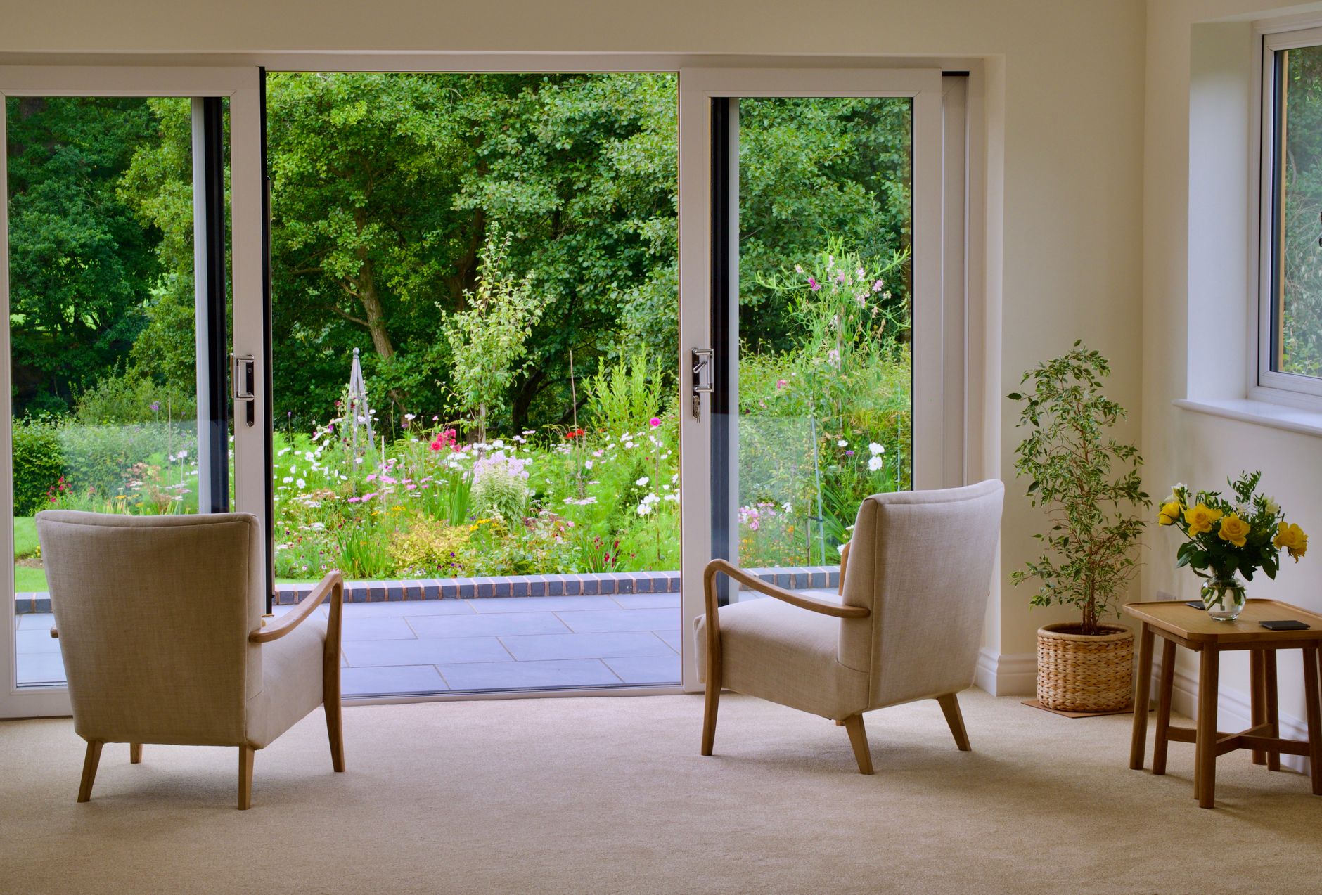 two chairs sitting in front of a large sliding door