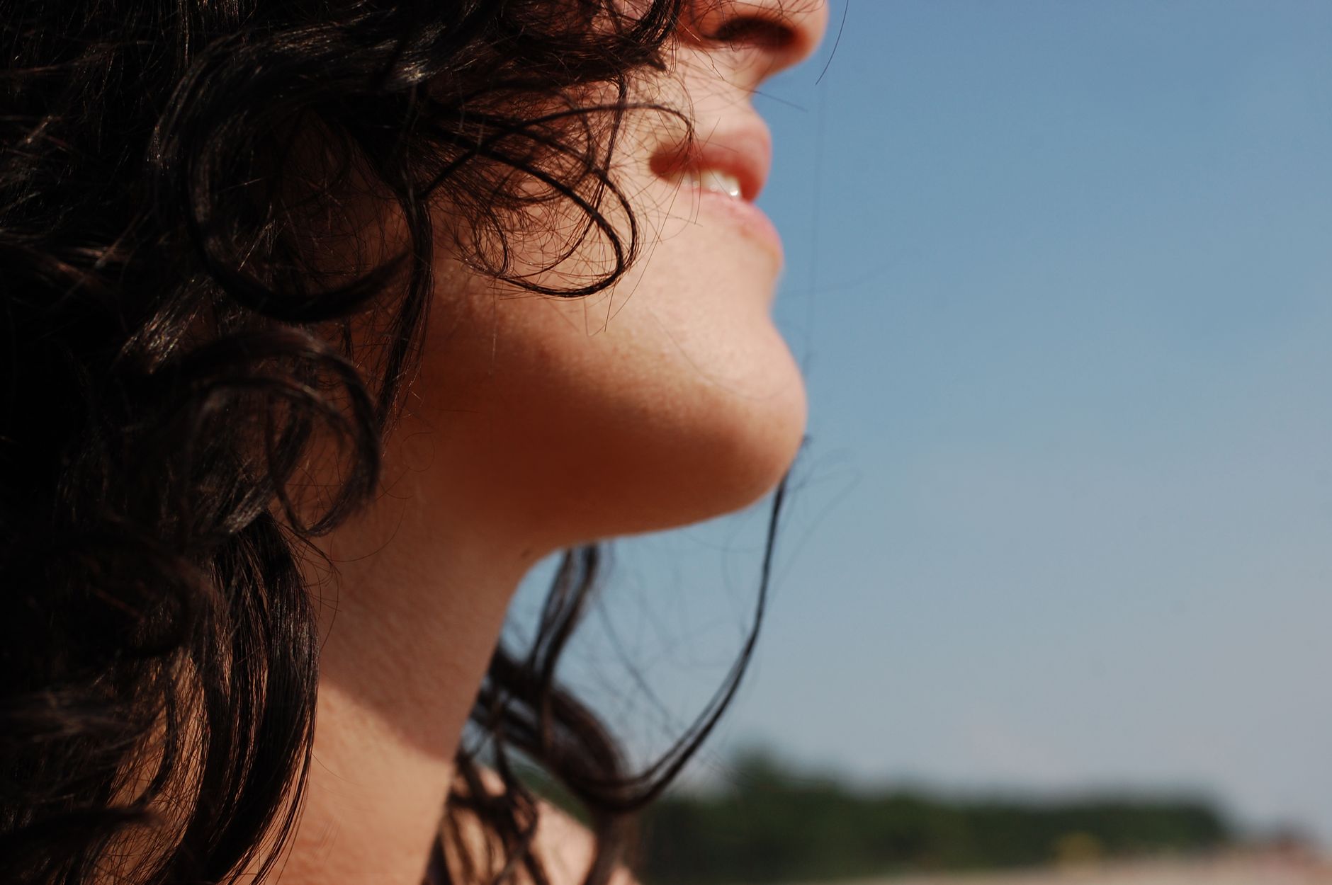 profile close up of woman outdoors in sunlight