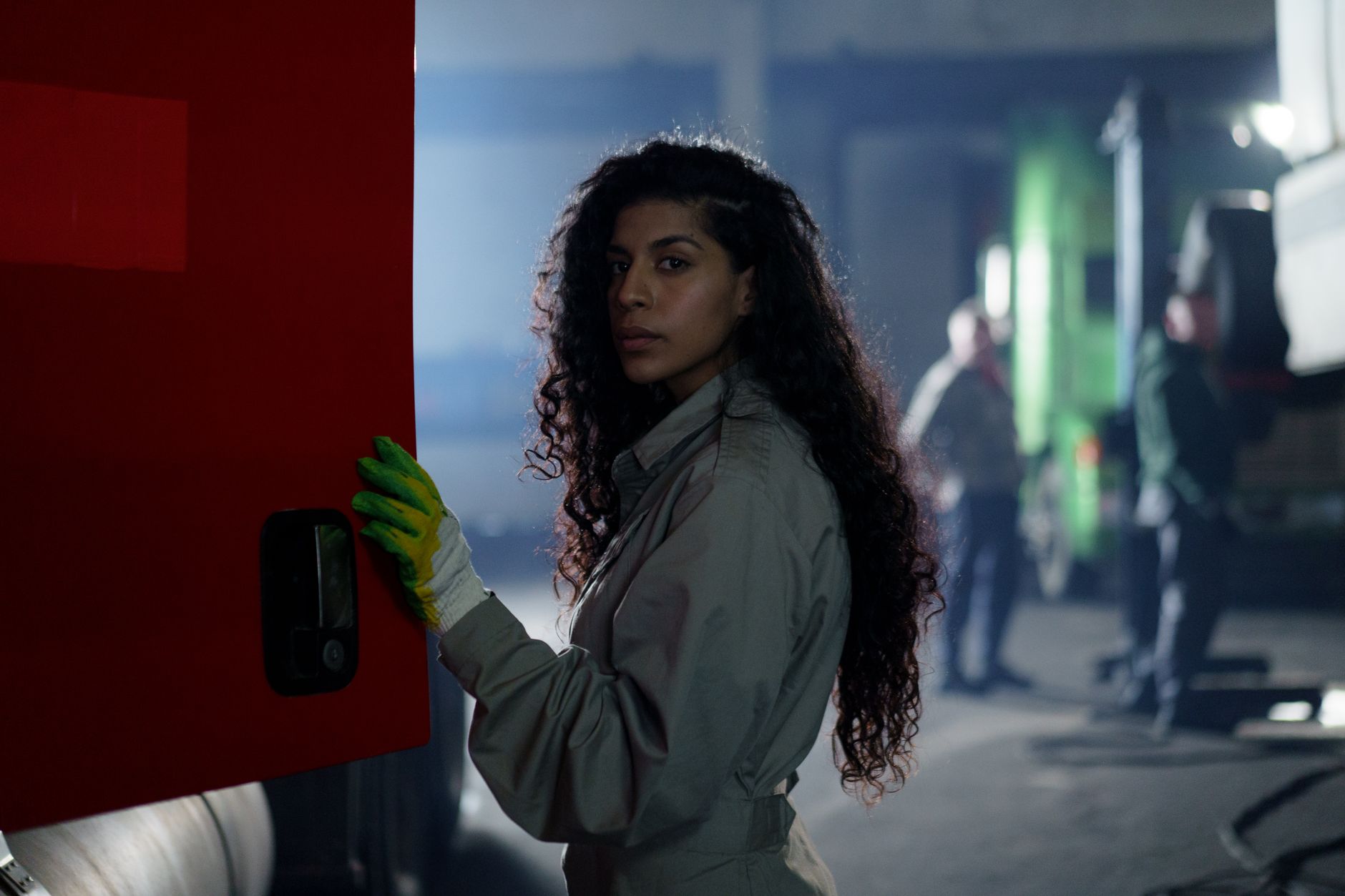 a woman wearing a coverall in the garage