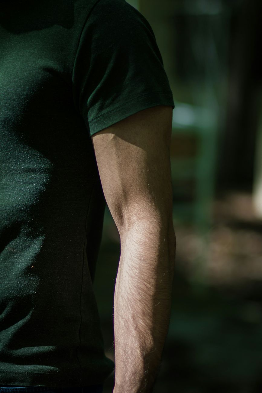 close up of an arm of a muscular man wearing a t shirt