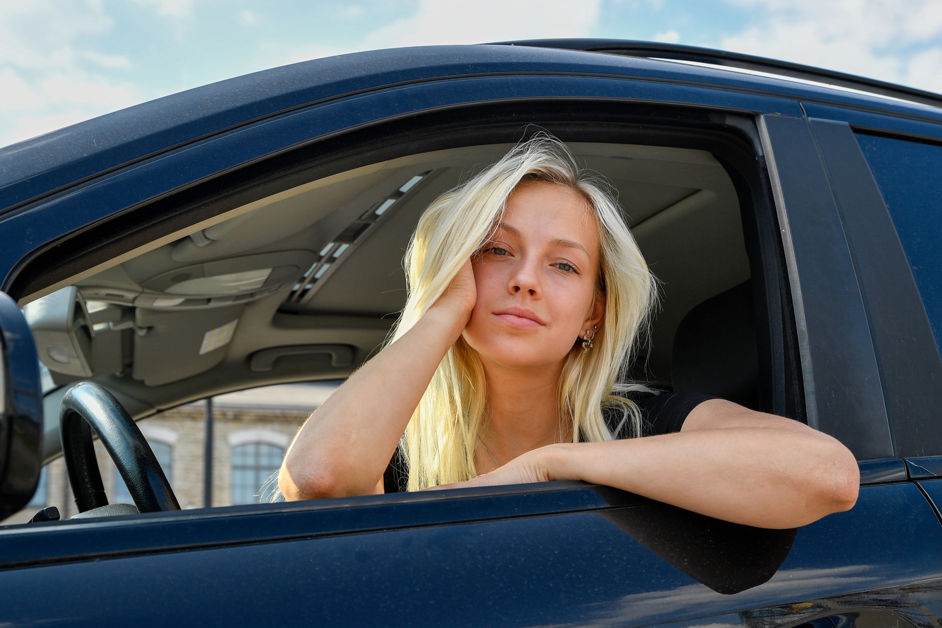 trendy young woman relaxing in car window