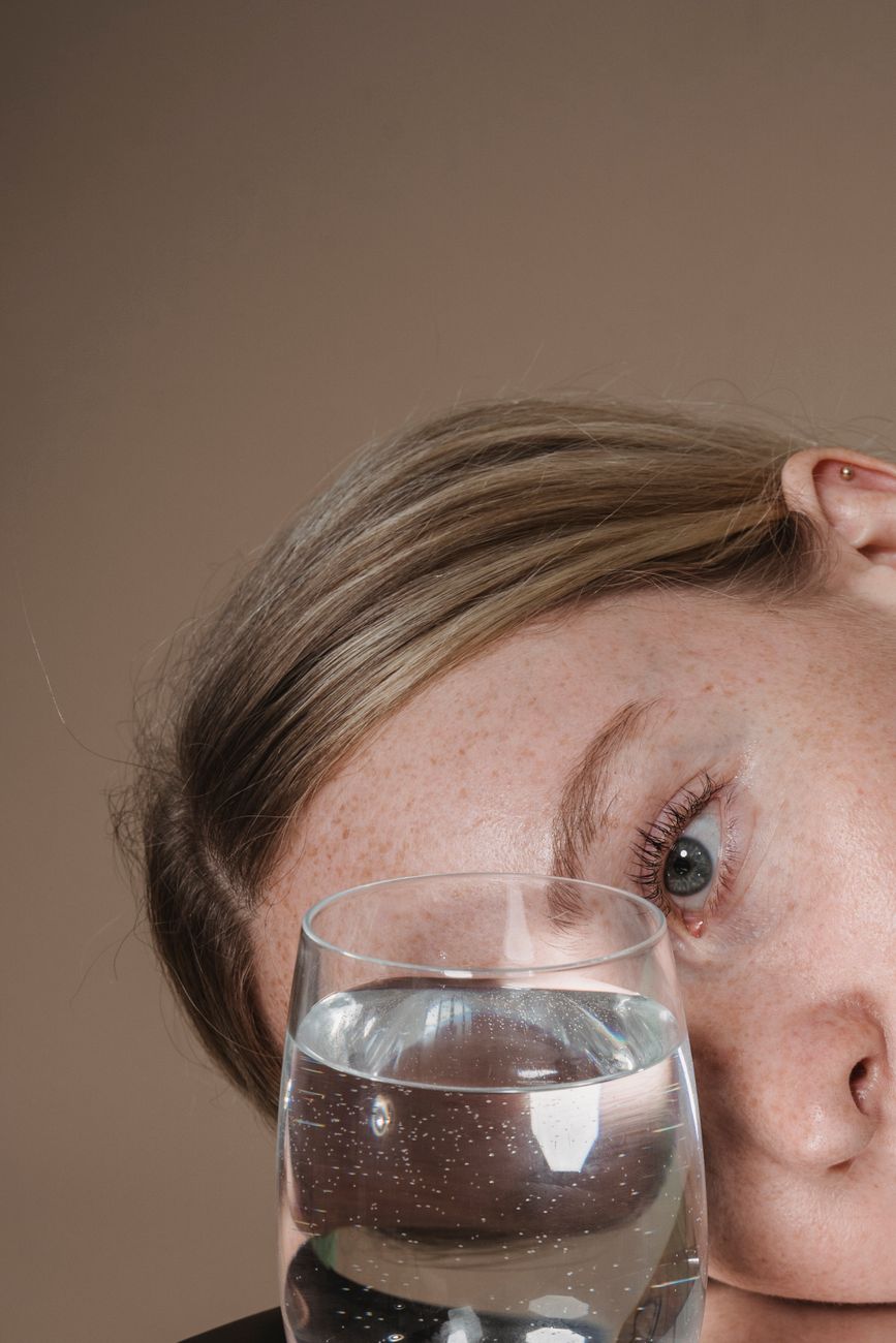 woman looking at glass of water